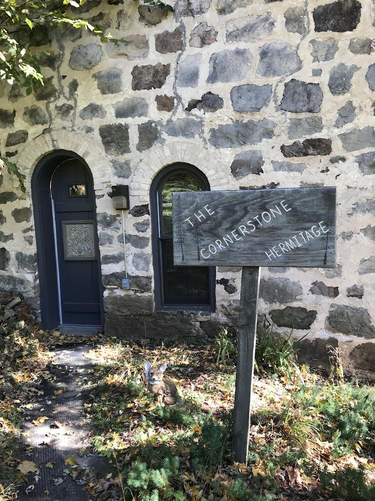 The Cornerstone Hermitage stone exterior with wooden sign